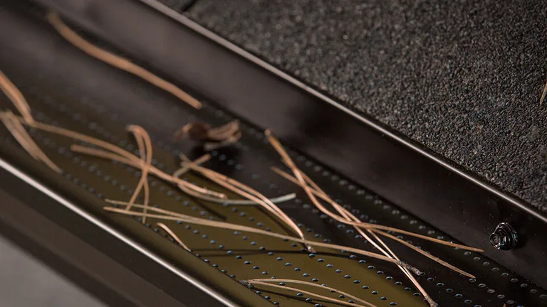 Close-up of the Alu-Rex DoublePro microfiltration continuous hanger on a shingle roof