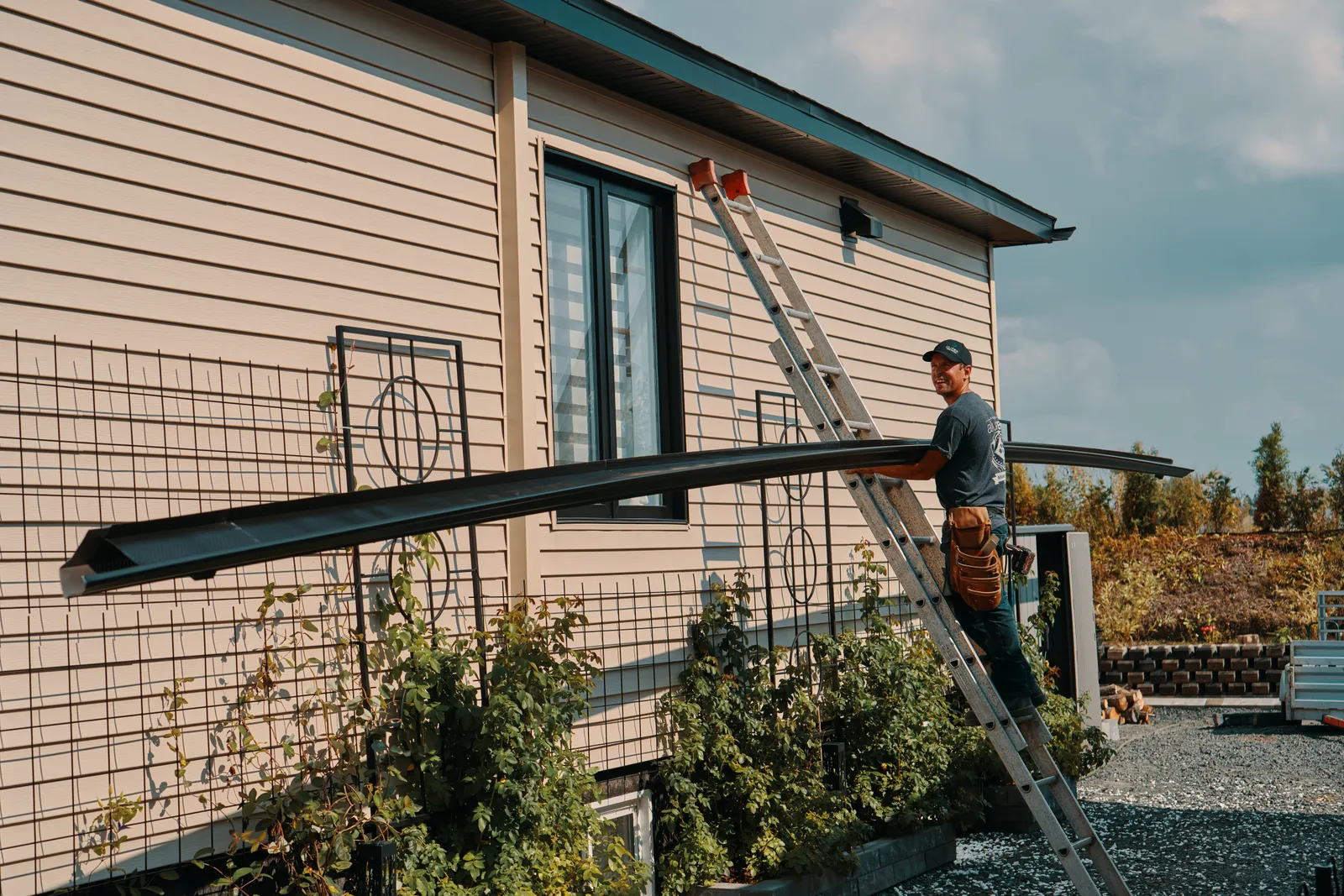 Downspout installation on a two-storey home — Rideau Rain Gutter, Harrowsmith BC